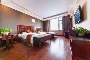 A hotel room with a large bed, a desk, a TV, and a window. - Junyi Chain Hotel (Sichuan Media College) (Chengdu)