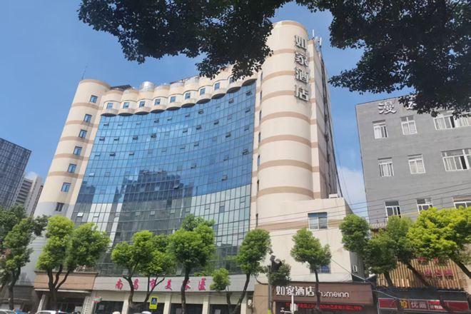 A multi-story hotel with a curved facade, large windows, and a prominent vertical feature on the right side.