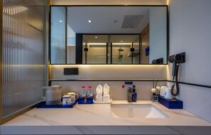 A modern bathroom with a large mirror, a sink, and a shower area. - Super 8 Collection Hotel Beijing Guomao Baiziwan Subway Station (Beijing)