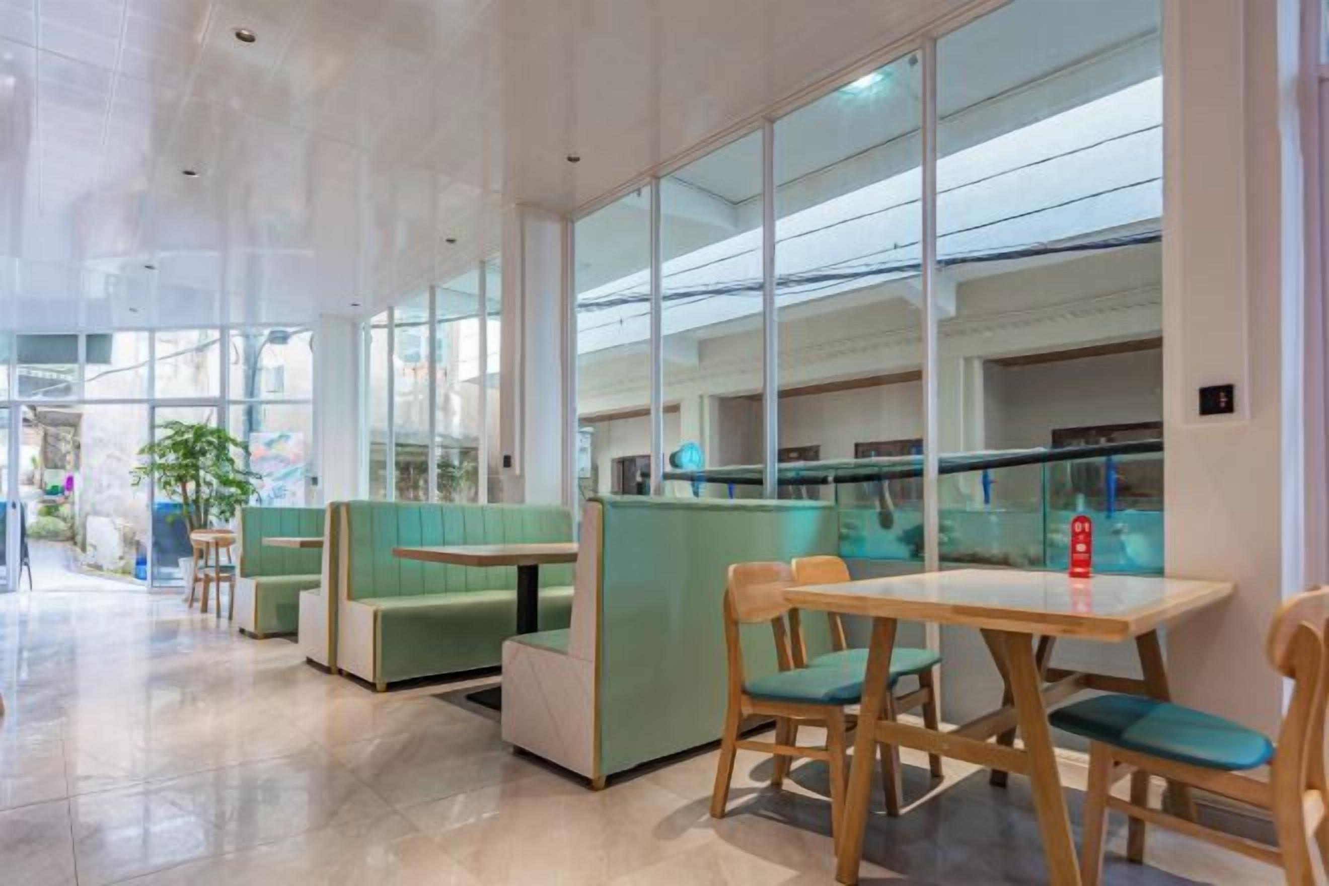 A modern interior with seating areas, a counter, and large windows.