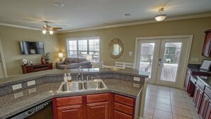 A spacious kitchen with granite countertops, wooden cabinets, and a built-in dishwasher. - New For 2025 - Waterfront Bayou Retreat: 25 Min to NOLA. (Barataria)