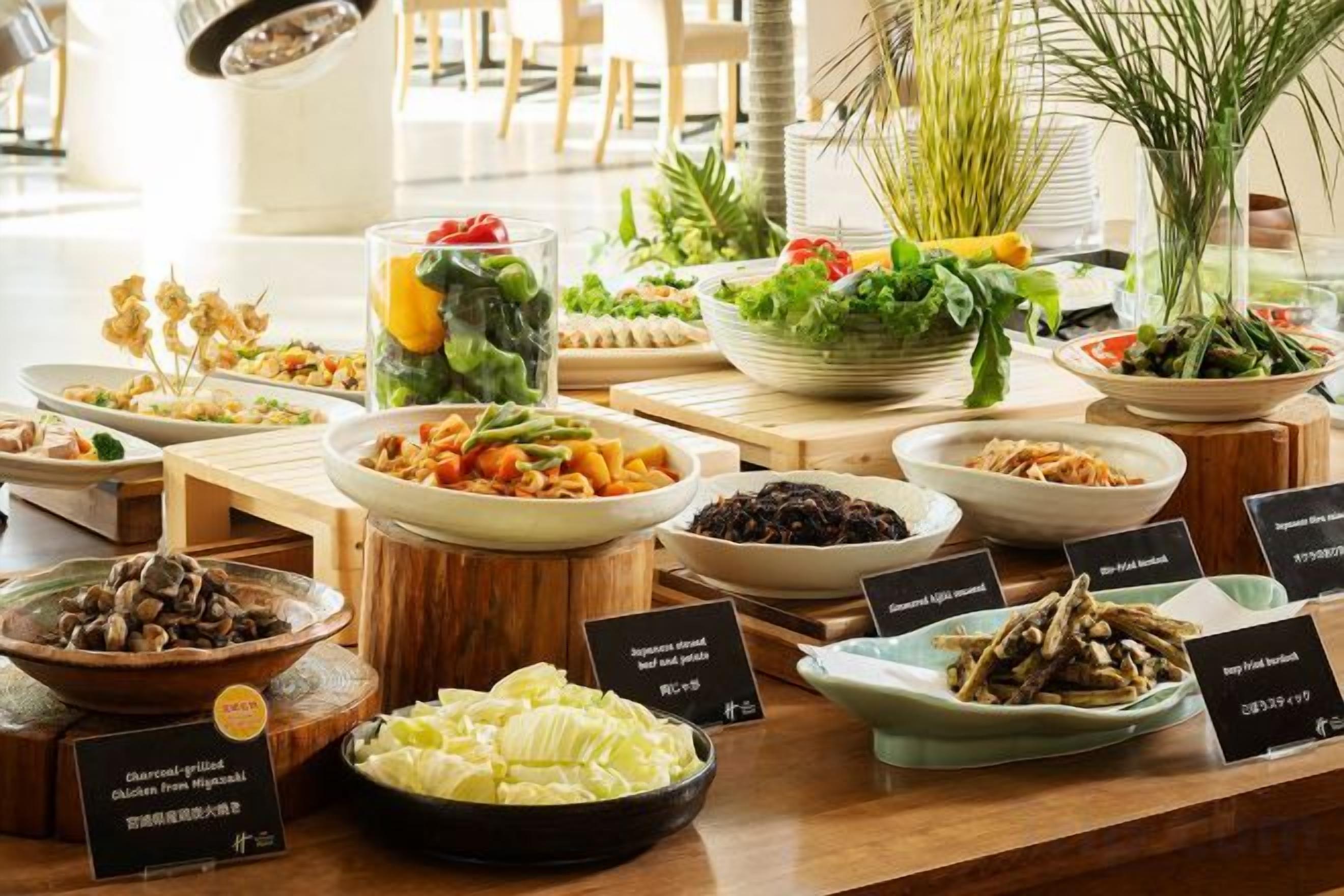 A buffet with various dishes and labels, likely in a hotel setting.