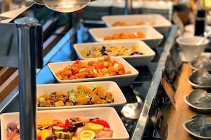 A buffet with various dishes arranged in rectangular trays. - Holiday Inn Resort MIYAZAKI by IHG (Miyazaki City)