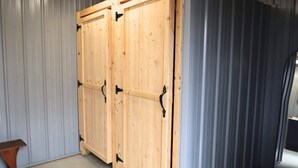 A room with two wooden doors and a metal-framed window.