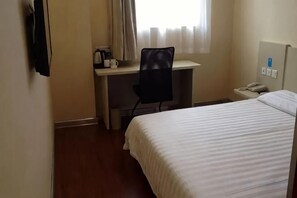 A hotel room with a bed, a desk with a chair, a telephone, and a window with curtains. - HanTing Hotel (Shanghai Daning Music Plaza Xindian) (Shanghai)