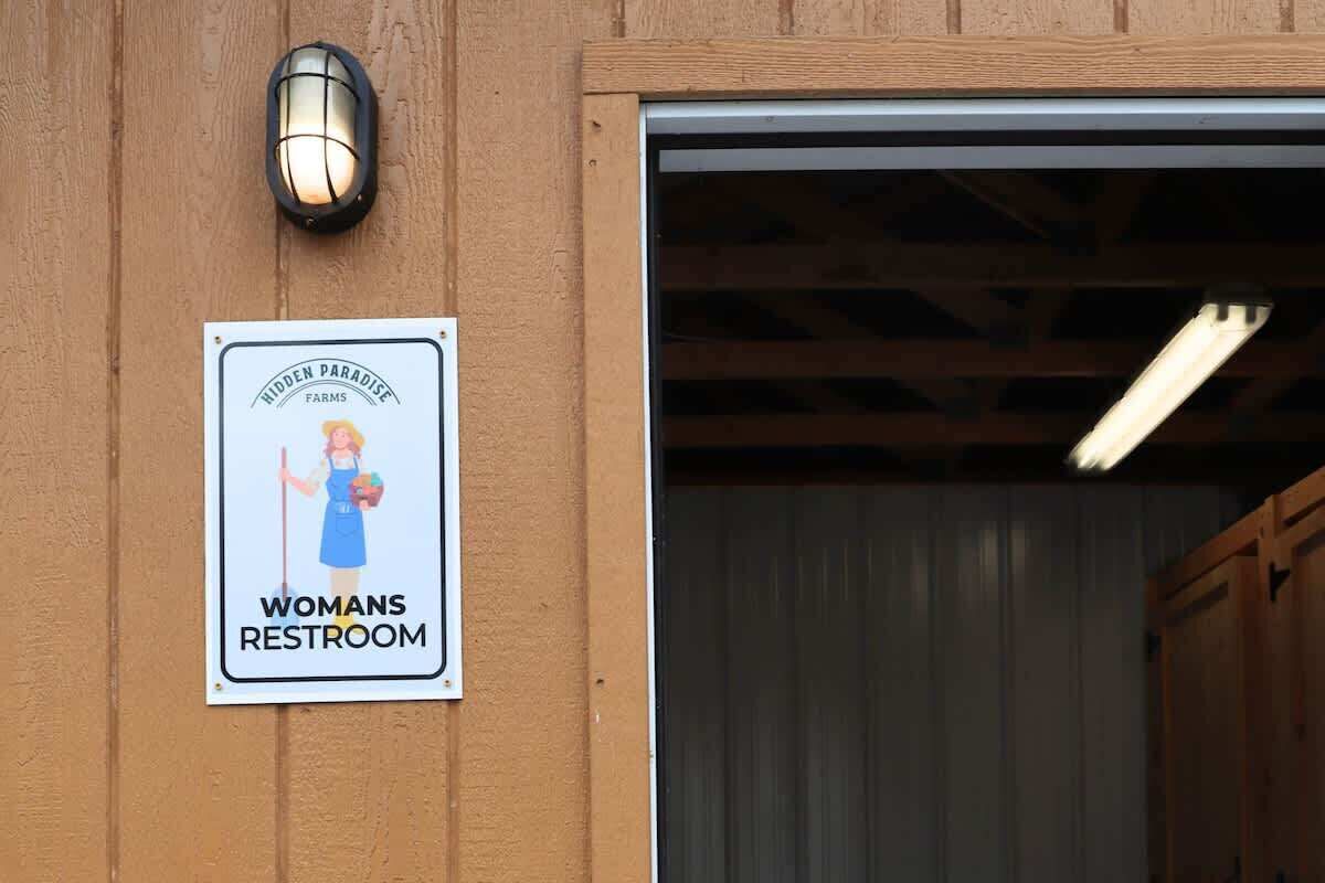 A sign for a women's restroom at Hidden Paradise Farms.