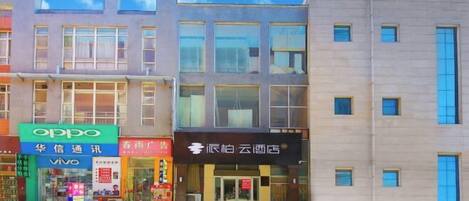Un edificio moderno con varias tiendas, incluyendo una tienda Oppo y un restaurante.