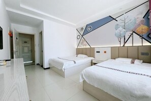 A hotel room with two beds, a desk, and a modern wall art piece.