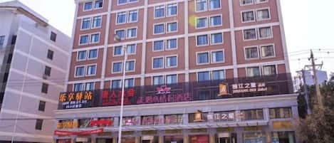 A multi-story hotel with a prominent signage for Jinjiang Inn.