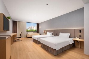 A hotel room with two beds, a desk, a chair, and a large window offering a city view. - Jinjiang Inn Select (Hubei University of Economics Branch, Wuhan Media College Branch) (Wuhan)
