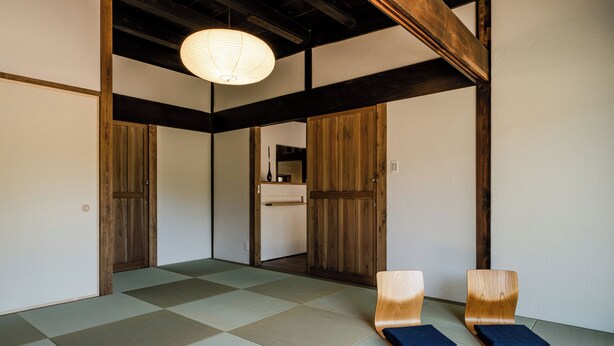 A traditional Japanese room with tatami flooring, wooden sliding doors, and a hanging paper lantern. - Tsuzuya Village, a guesthouse with a full-fledged private sauna (Minokamo)