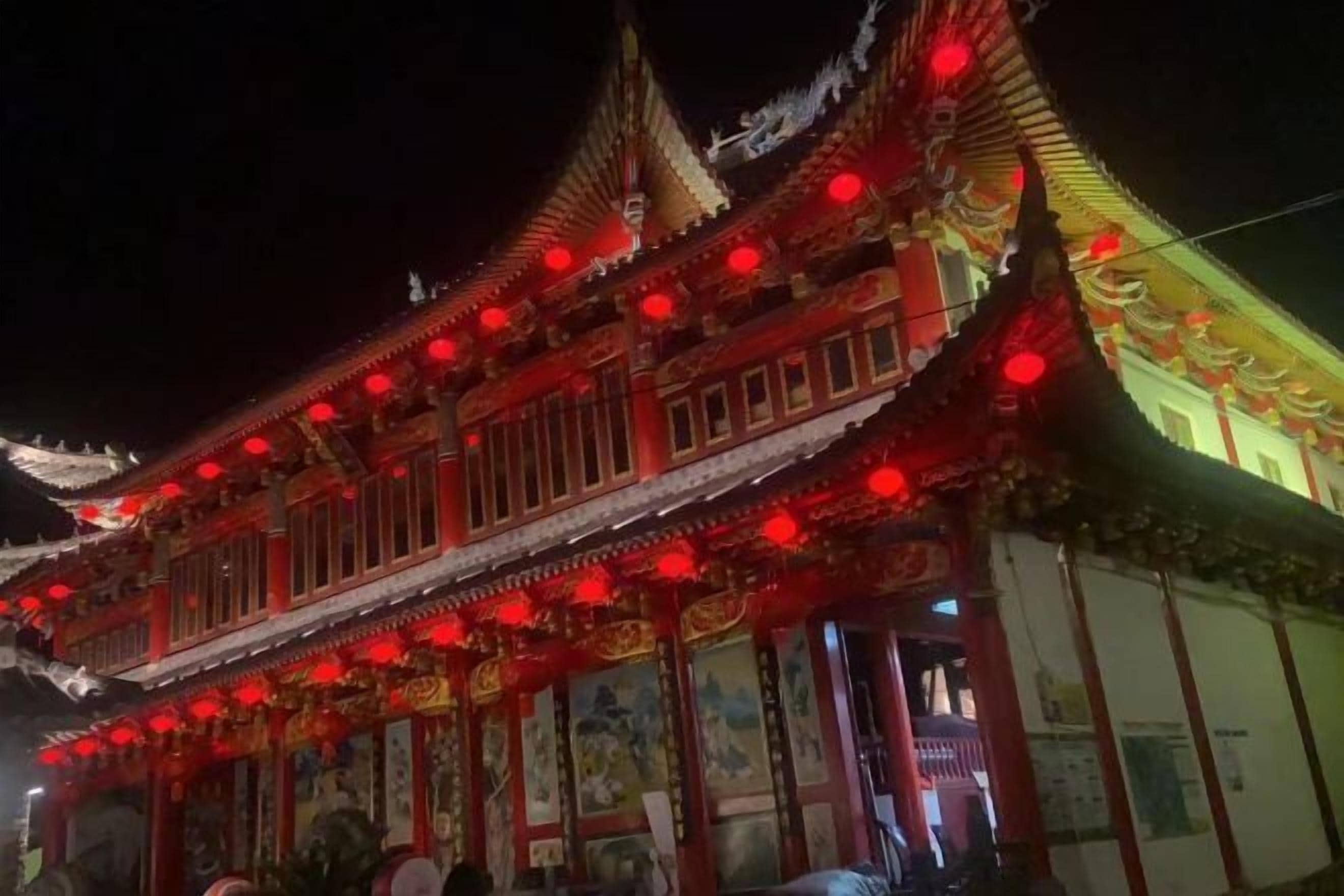 A traditional building with ornate architecture and red lanterns.