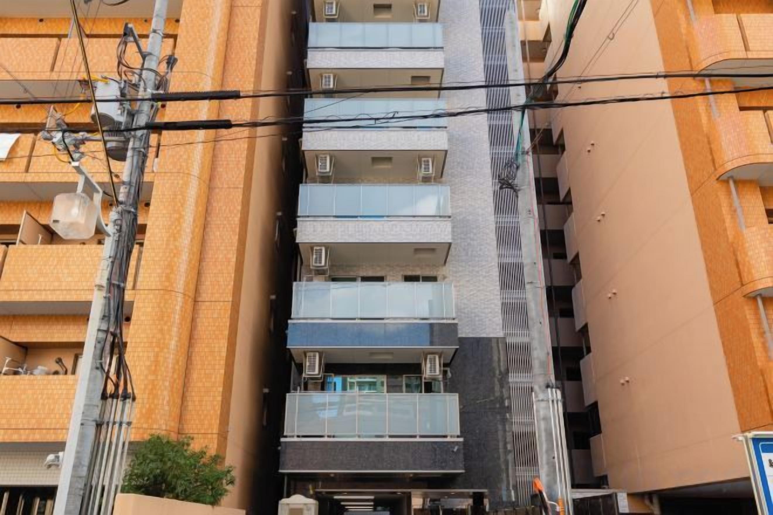 A multi-story building with balconies and a central staircase.