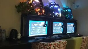 A room with a desk featuring two monitors, a keyboard, and a mouse. There are two patterned cushions on the sofa. - Zichen Express Hotel (Santajizhen People's Government Branch) (Fuyang)