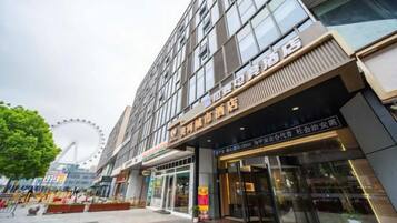 A hotel with a modern facade, large windows, and a prominent entrance.