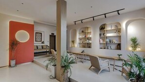 A modern living room with a large bookshelf, a wooden table, and several chairs. - When we first meet (Dali City)