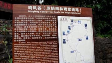 A sign with text and a map, likely providing information about a location.