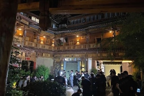 A traditional multi-story building with wooden balconies and a central courtyard.