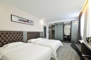A hotel room with two beds, a large mirror, a desk, and a bathroom visible through a glass door. - Jichu hotel (Jingzhou ocean world store) (Jingzhou)