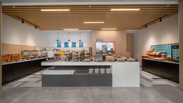 A modern buffet setup with a central serving area, multiple food stations, and a clean, contemporary design.