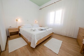 A bedroom with a single bed, bedside tables, a nightstand, a dresser, and a window with curtains. - Oasis of Peace in Lopar /w Terrace, Lopar, Croatia (Lopar)