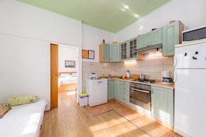 A compact kitchen with a refrigerator, stove, and microwave. - Oasis of Peace in Lopar /w Terrace, Lopar, Croatia (Lopar)