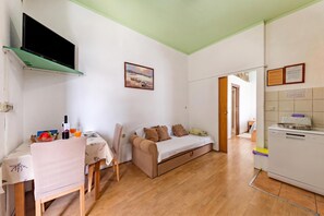 A compact living space with a kitchenette, a dining area, and a sofa. - Oasis of Peace in Lopar /w Terrace, Lopar, Croatia (Lopar)