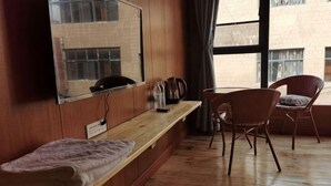 A room with a wooden floor, a wooden bench, a chair, a table, a mirror, and a window. - Xiaoluo Ha'ni Titian Sheying Zhijia Hostel (Yuanyang)