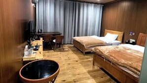 A hotel room with a wooden floor, a bed with a brown blanket, a desk with a chair, a television, and a large window with curtains. - Xiaoluo Ha'ni Titian Sheying Zhijia Hostel (Yuanyang)