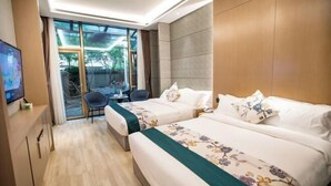 A hotel room with two beds, a TV, a desk with a chair, and a view through a glass door. - Hongting Garden Hotel (Kunming)