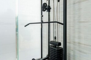 A gym with a pull-up bar and a stationary bike. - Easy Go Inn (Shanghai Hangtou Hunan Highway Store) (Shanghai)