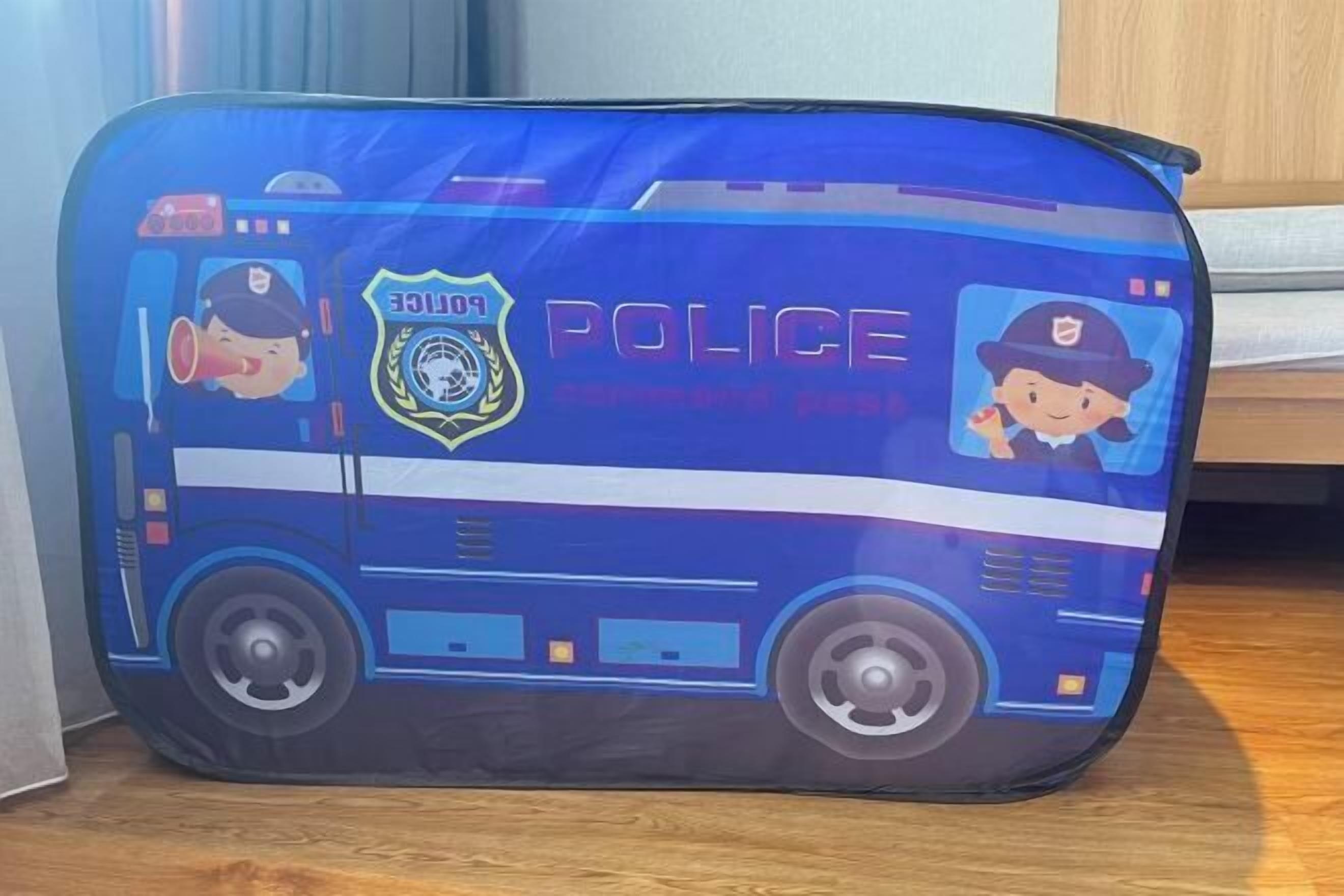 A blue suitcase with police-themed designs, including a police car and badge.
