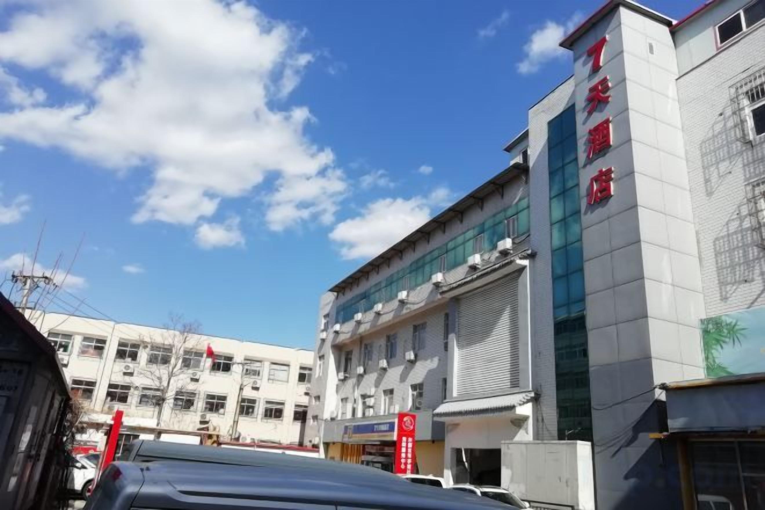 A building with multiple floors, large windows, and a clear sky.