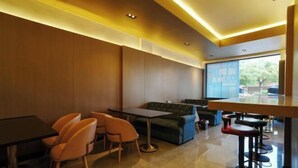 A modern interior with a bar area, seating, and a large window. - Qingya Hotel (Jiaxing Wangdian) (Jiaxing)