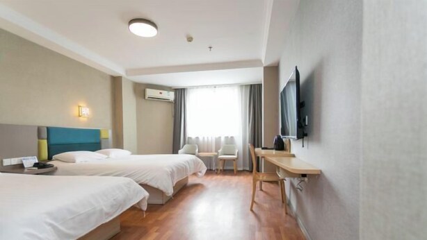 A hotel room with two beds, a desk, a chair, a flat-screen TV, and a window with curtains. - Xinrenren hotel (Shanghai)