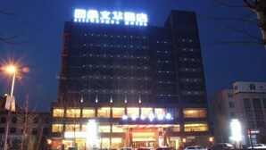 A multi-story hotel with a prominent sign at the top. - Sijiwenhua Hotel (Feicheng)