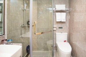 A modern bathroom with a glass shower enclosure, a white toilet, and a marble-tiled wall. - Qingmu Hotel (Nanjing Wutaishan Guangzhou Road Suiyuan Building) (Nanjing)