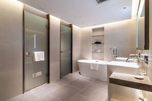 A modern bathroom with a glass shower enclosure, a freestanding bathtub, and a vanity with a mirror. - Landmark International Hotel(East Railway Station Tianhe Sport Center Branch) (Guangzhou)