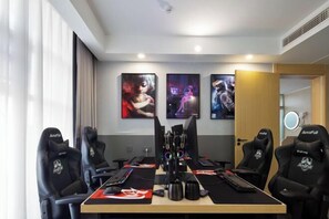 Relax and compete in style with a dedicated gaming room featuring a large table and four comfortable chairs.