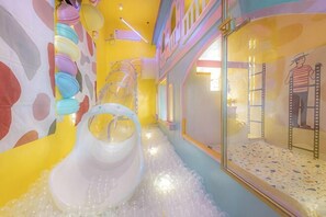 A children's play area with slides and climbing structures.