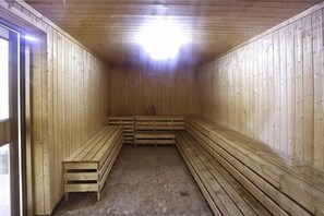 Una sauna con bancos de madera y techo inclinado.