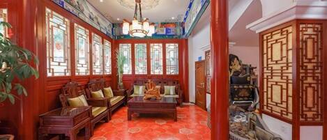 A traditional interior with wooden furniture, a patterned floor, and decorative elements.