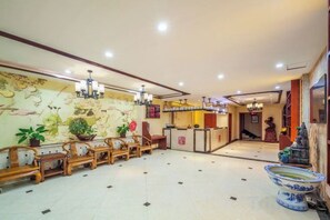 A hotel lobby with a reception desk, seating area, and decorative elements. - Jingyue Hotel (Kangning street, Taiyuan Economic Development Zone) (Taiyuan)
