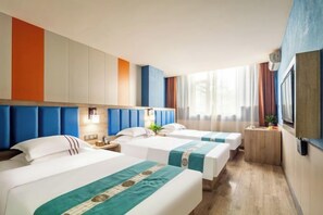 A hotel room with three beds, a small desk, a TV, and a window with curtains. - Jingyue Hotel (Kangning street, Taiyuan Economic Development Zone) (Taiyuan)