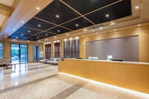A hotel lobby with a reception desk, seating area, and large windows. - GreenTree Alliance Hotel (Huzhou South Taihu Hospital) (Huzhou)