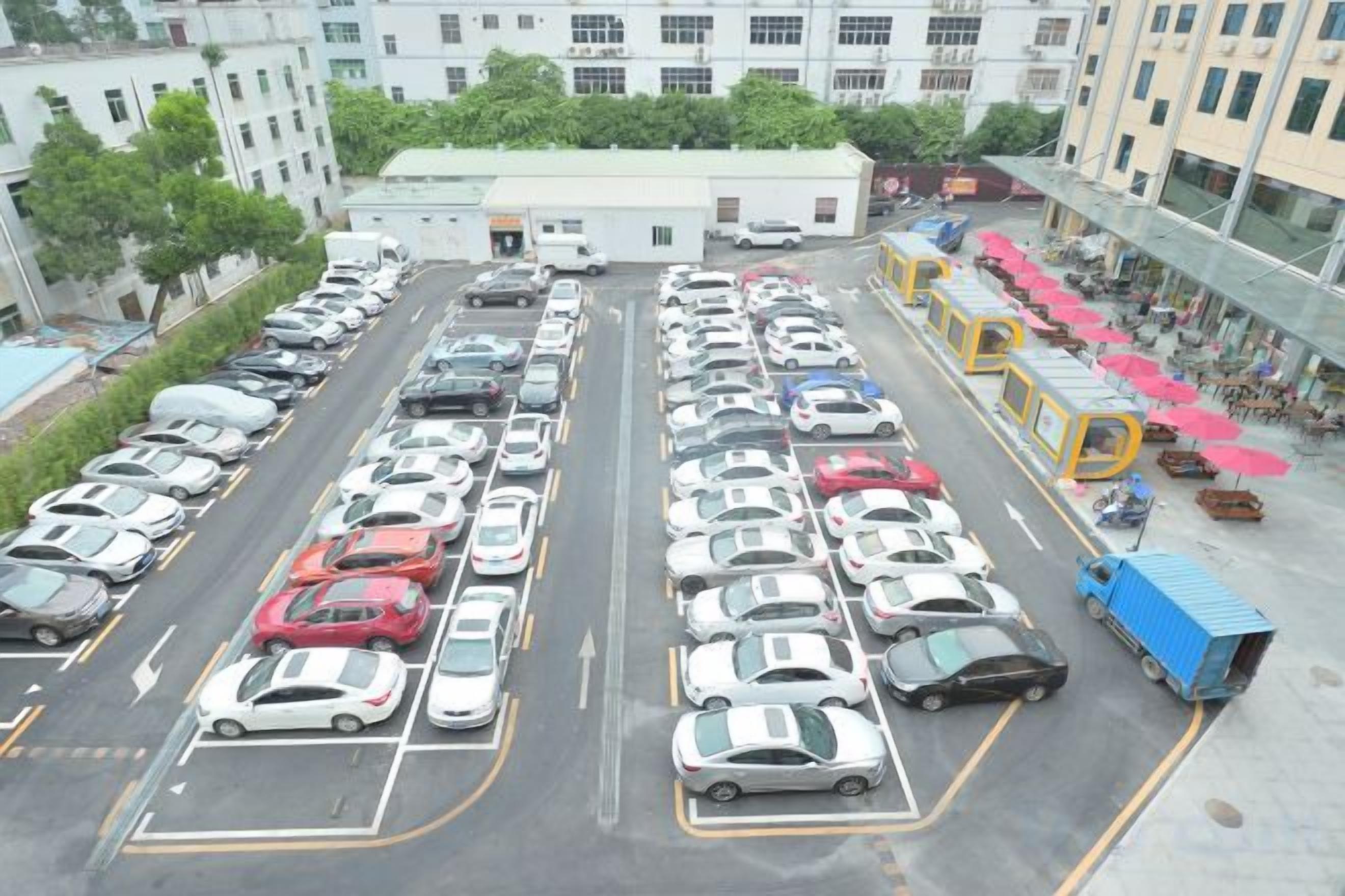 A multi-level parking structure with numerous cars parked in organized rows.
