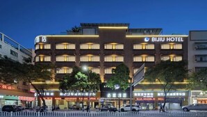 A hotel with multiple floors, a prominent sign for 'BIJIU HOTEL', and several ground-level shops. - BIJIU HOTEL (Foshan)