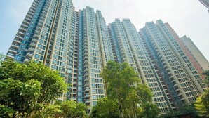 A high-rise residential building with multiple balconies and a modern architectural design.
