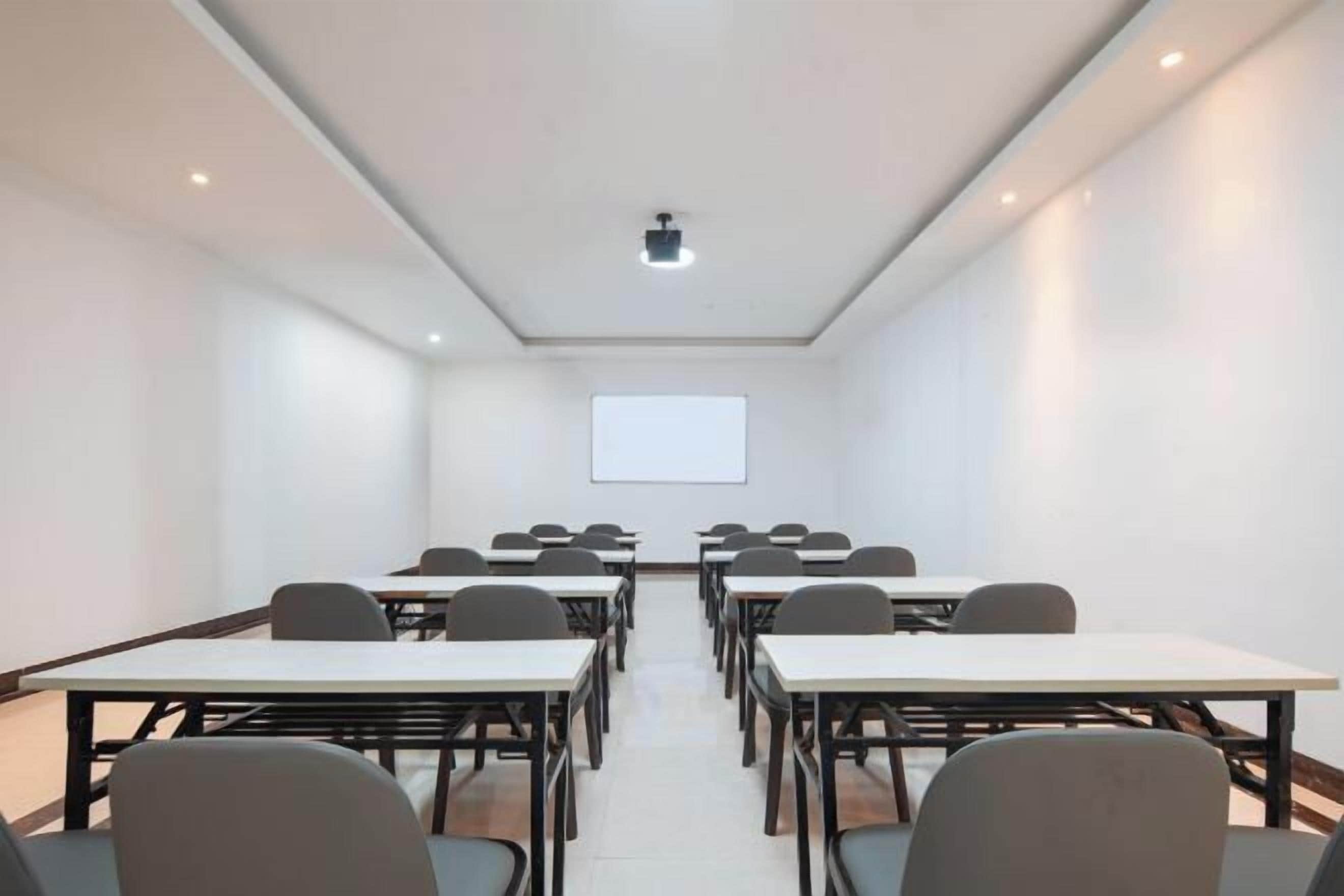 A conference room with tables and chairs arranged for meetings.