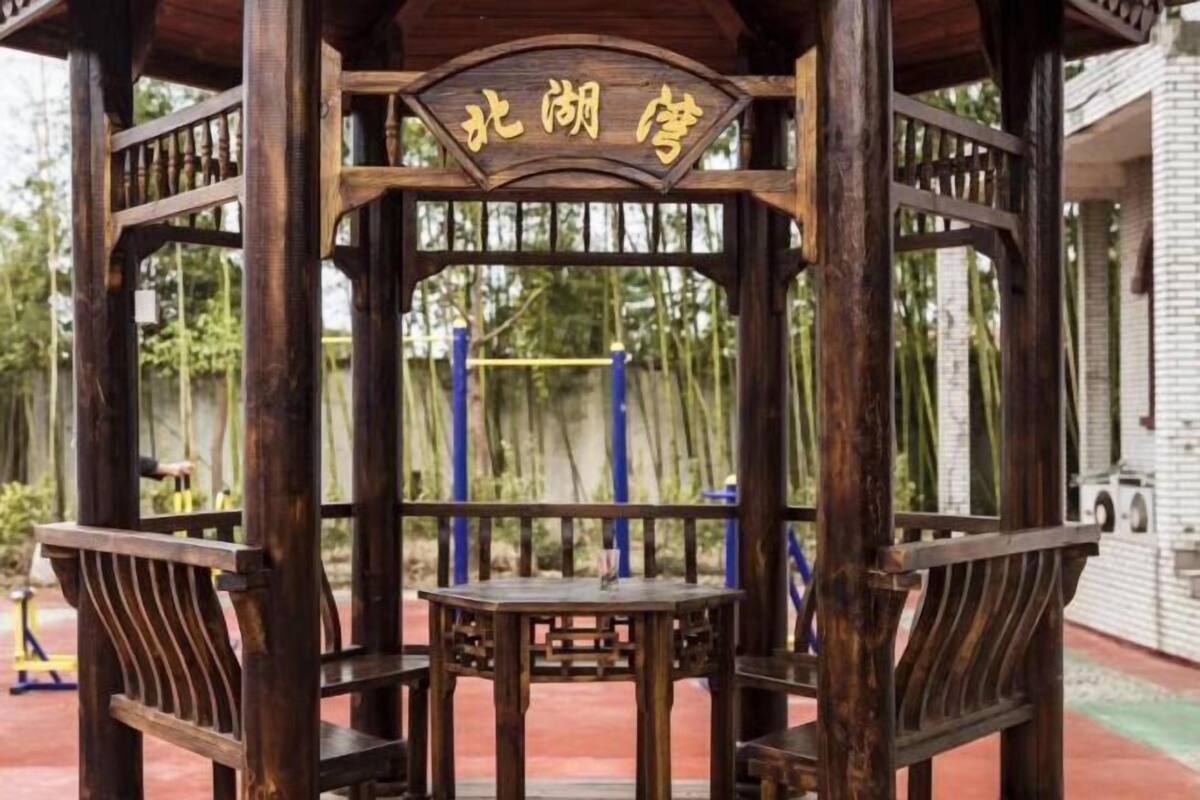 A wooden gazebo with a sign that reads "Northern Pavilion".